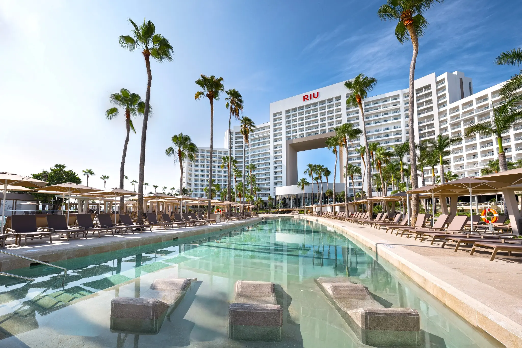 Refurbished pool with submerged loungers at RIU Palace Peninsula in Cancun