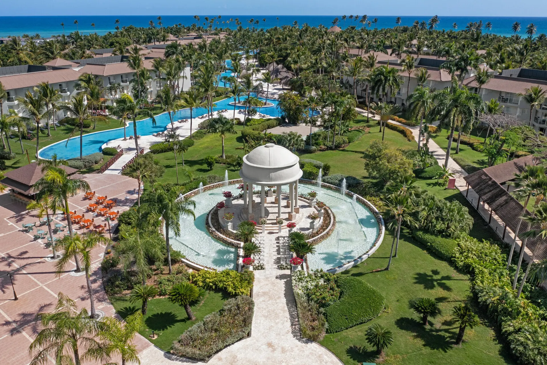 Aerial view of Wyndham Alltra Punta Cana's garden wedding gazebo, tropical grounds, pool, and Caribbean coastline